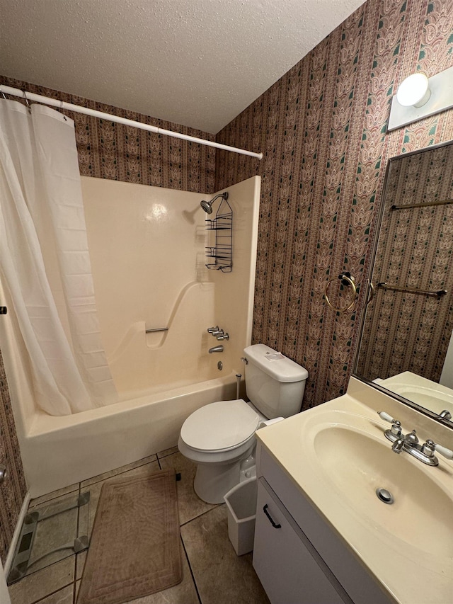 full bathroom with tile patterned floors, a textured ceiling, toilet, shower / bath combo with shower curtain, and vanity