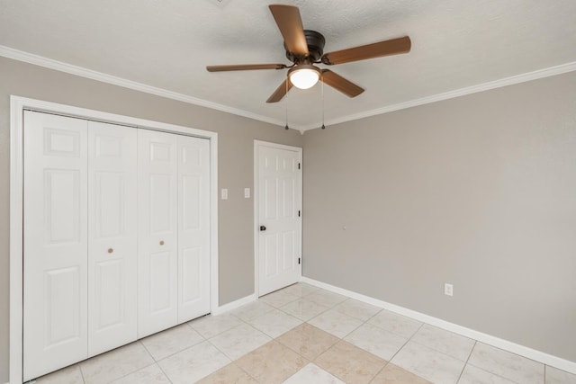 unfurnished bedroom with ornamental molding, a closet, light tile patterned flooring, and baseboards