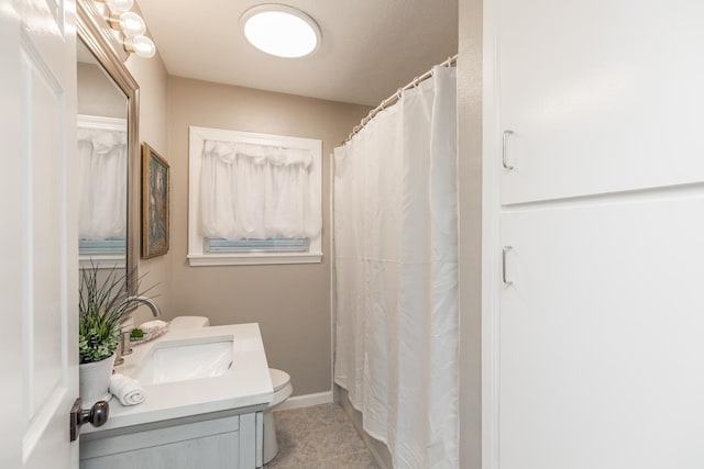 full bathroom featuring baseboards, vanity, toilet, and tile patterned floors