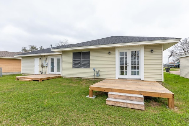 back of house featuring a yard, a deck, and french doors