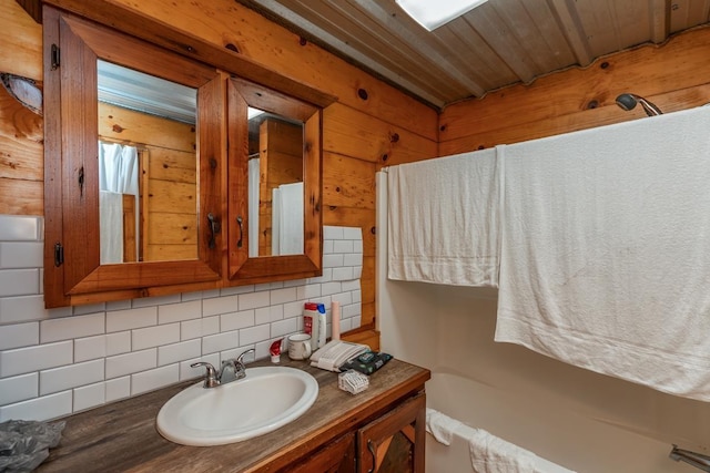 3075 Shivers St, Vidor, TX 77662 - bathroom with backsplash, vanity, and a tub
