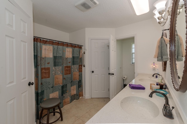 bathroom with tile patterned flooring, vanity, a textured ceiling, and a shower with shower curtain