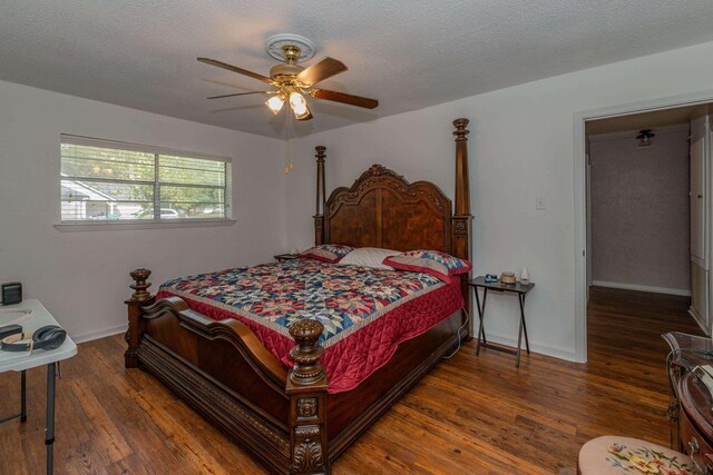 bedroom featuring ceiling fan, dark hardwood / wood-style flooring, and a textured ceiling