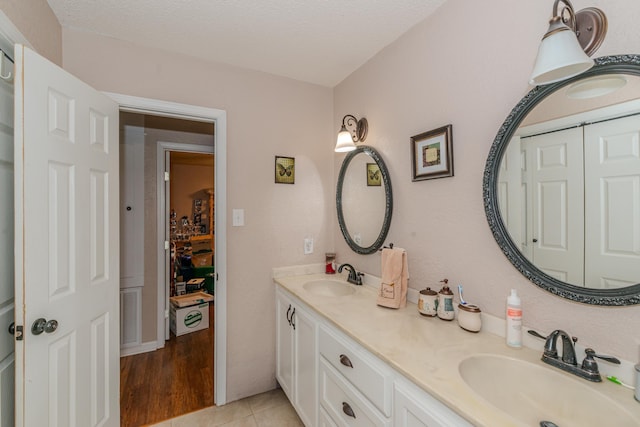 bathroom featuring a textured ceiling, vanity, and tile patterned floors