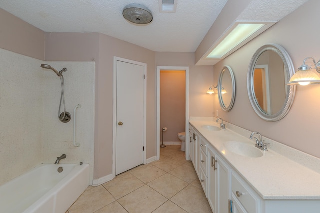 full bathroom with tile patterned flooring, vanity, toilet, and a textured ceiling