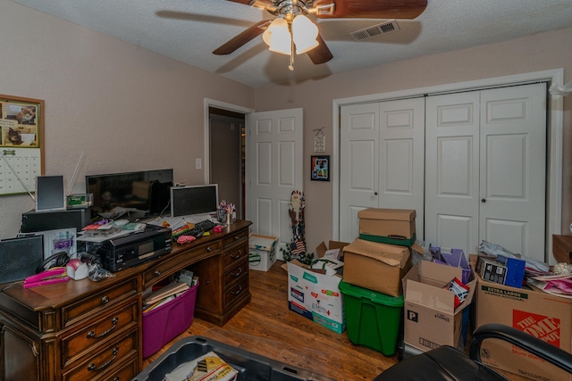 home office with hardwood / wood-style flooring, ceiling fan, and a textured ceiling