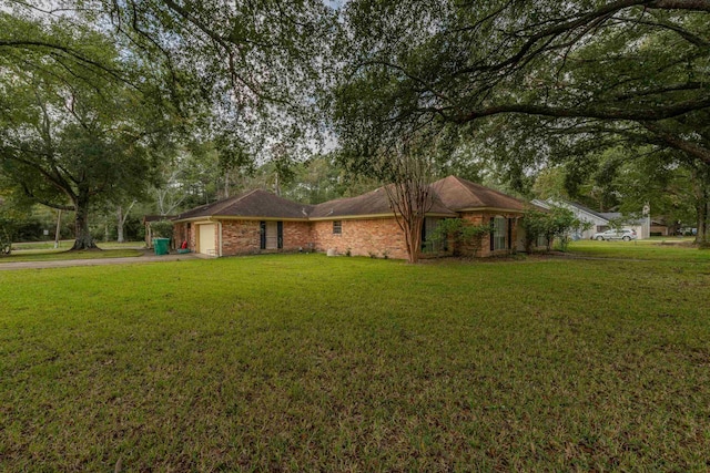 ranch-style home featuring a front yard and a garage