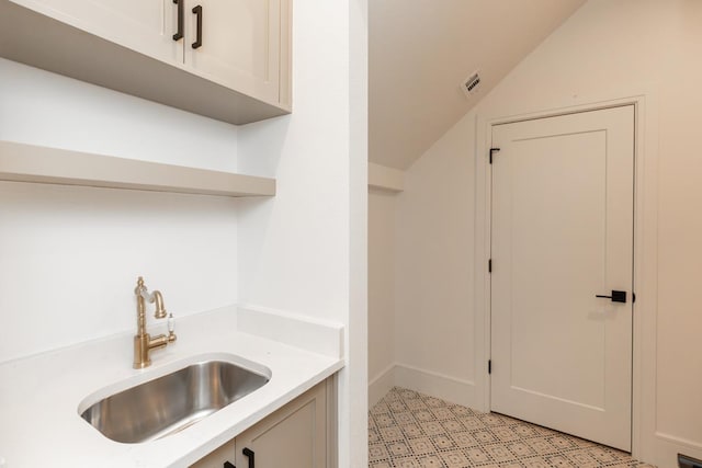 3570 Lily Ln, Beaumont, TX 77713 - kitchen featuring a sink, light countertops, vaulted ceiling, and open shelves