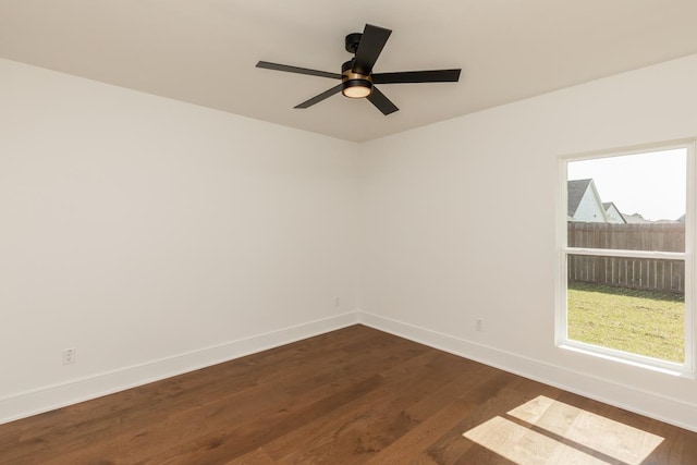 3570 Lily Ln, Beaumont, TX 77713 - empty room with dark wood finished floors, baseboards, healthy amount of natural light, and ceiling fan