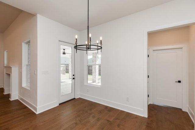 3570 Lily Ln, Beaumont, TX 77713 - unfurnished dining area with a chandelier, dark wood-type flooring, and baseboards