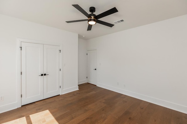 3570 Lily Ln, Beaumont, TX 77713 - unfurnished bedroom with wood finished floors, baseboards, and ceiling fan