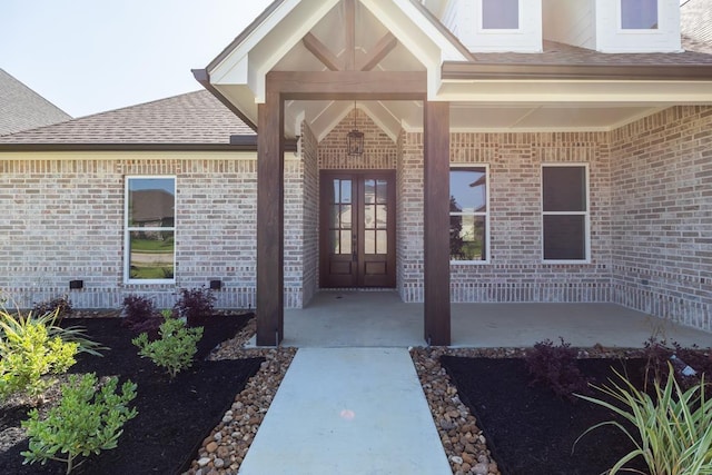 3570 Lily Ln, Beaumont, TX 77713 - entrance to property with french doors, brick siding, and roof with shingles