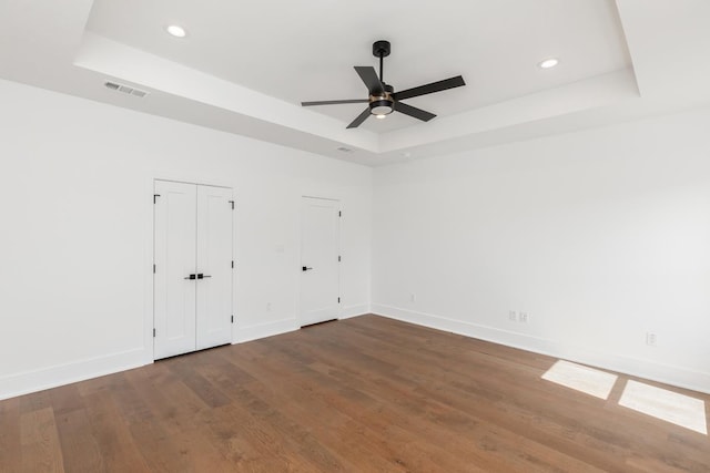 3570 Lily Ln, Beaumont, TX 77713 - unfurnished bedroom with a raised ceiling, baseboards, wood finished floors, and recessed lighting