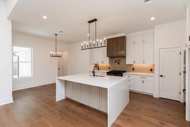 3570 Lily Ln, Beaumont, TX 77713 - kitchen with a sink, a chandelier, range, backsplash, and white cabinets
