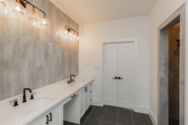 3570 Lily Ln, Beaumont, TX 77713 - full bath with tile patterned floors, double vanity, and baseboards