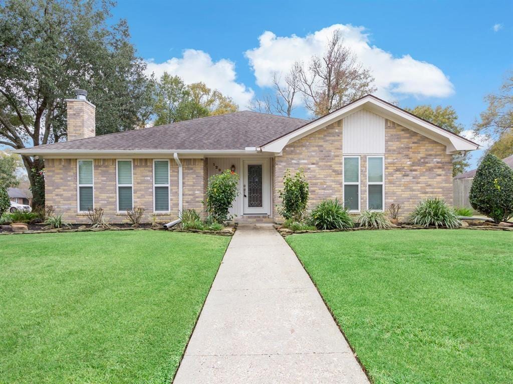 12955 Mintwood Dr, Beaumont, TX 77706 - single story home with a chimney, a front lawn, and brick siding