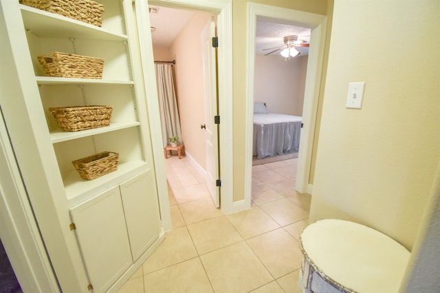 hall with built in features and light tile patterned floors