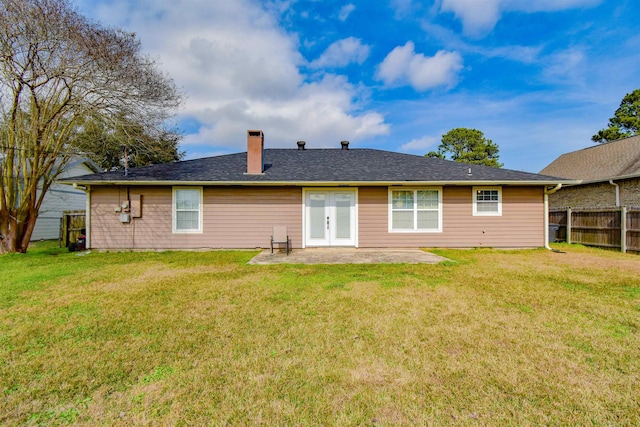 back of house with a patio area and a lawn