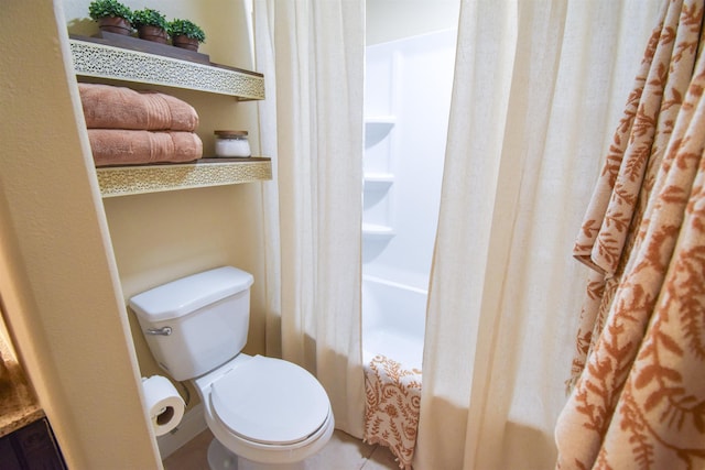 bathroom with tile patterned flooring, shower / tub combo with curtain, and toilet