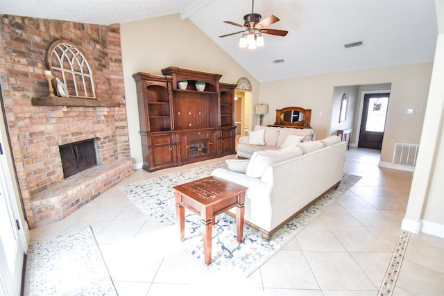 tiled living room featuring beam ceiling, ceiling fan, a brick fireplace, and high vaulted ceiling