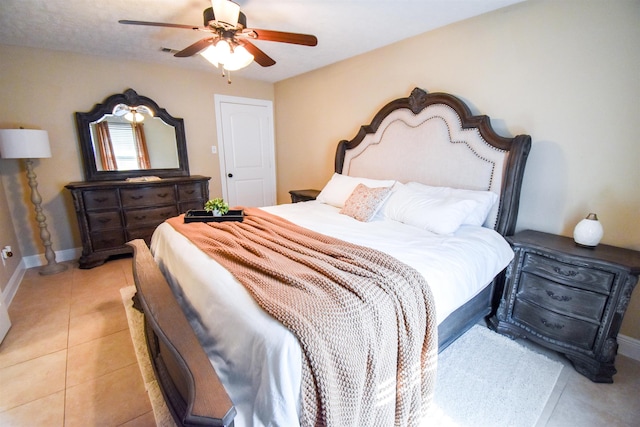 bedroom featuring light tile patterned floors and ceiling fan