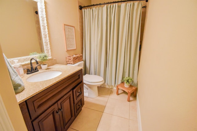 bathroom featuring vanity, toilet, and tile patterned flooring