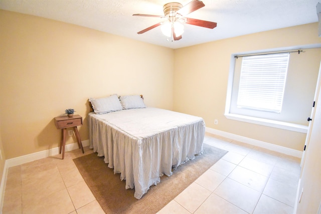 tiled bedroom featuring ceiling fan