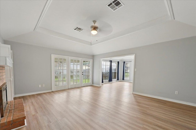 1120 Meadowvale Dr, Beaumont, TX 77706 - unfurnished living room featuring a tray ceiling, a ceiling fan, light wood-type flooring, and a fireplace