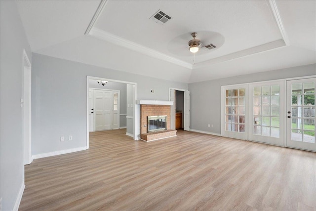 1120 Meadowvale Dr, Beaumont, TX 77706 - unfurnished living room with a raised ceiling, a ceiling fan, light wood finished floors, and a brick fireplace