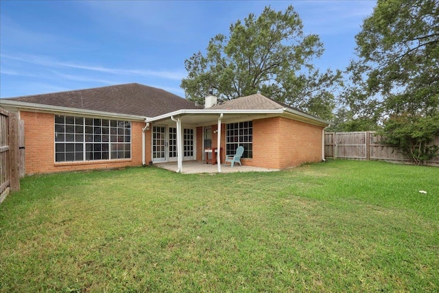 1120 Meadowvale Dr, Beaumont, TX 77706 - rear view of property with brick siding, french doors, a fenced backyard, and a patio area