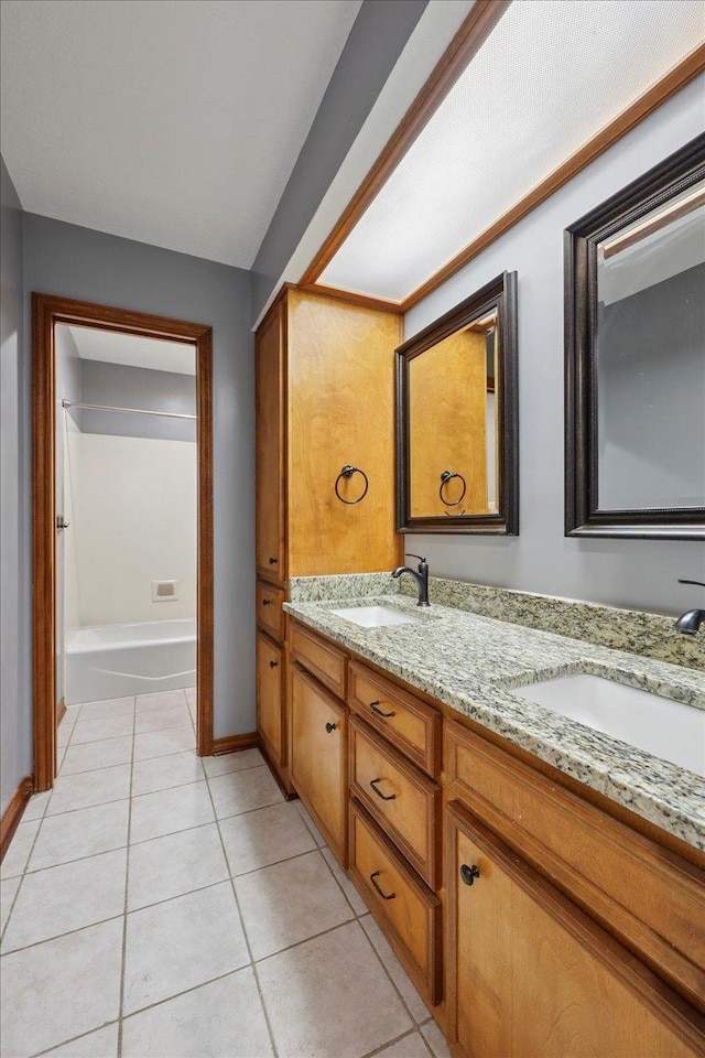 1120 Meadowvale Dr, Beaumont, TX 77706 - bathroom with double vanity, tile patterned floors, and a bath