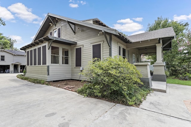 view of side of home with covered porch