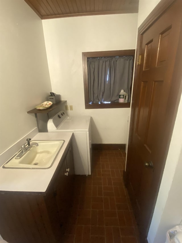 laundry room featuring washer and dryer, cabinets, wooden ceiling, and sink