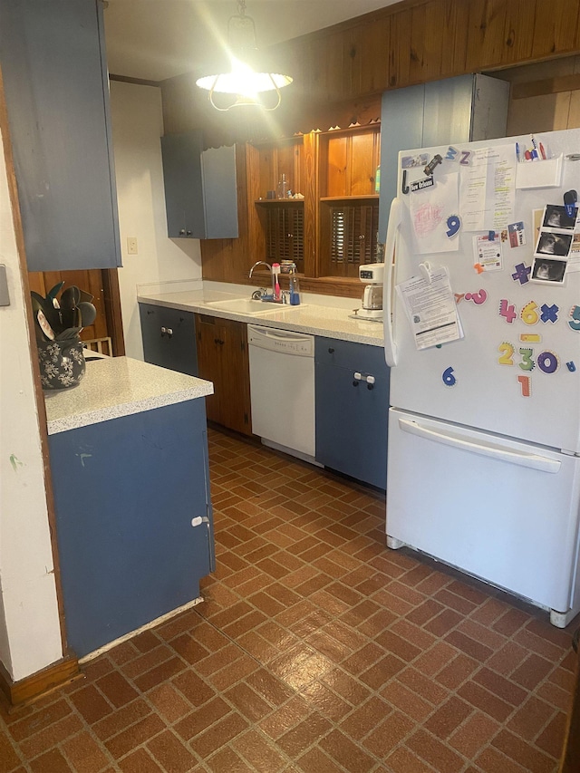 kitchen with white appliances, gray cabinetry, and sink