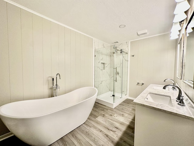 bathroom with separate shower and tub, crown molding, a textured ceiling, vanity, and hardwood / wood-style flooring