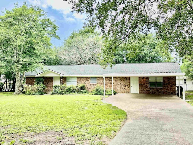 ranch-style home featuring a carport and a front yard