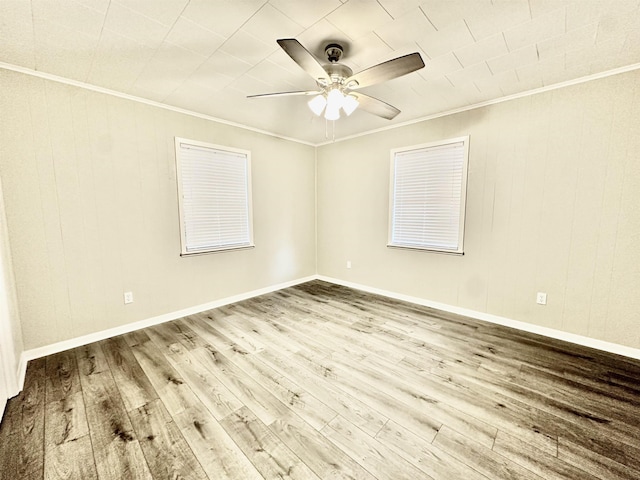 spare room with crown molding, ceiling fan, and wood-type flooring