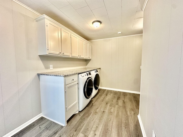 laundry room with crown molding, cabinets, light wood-type flooring, and independent washer and dryer