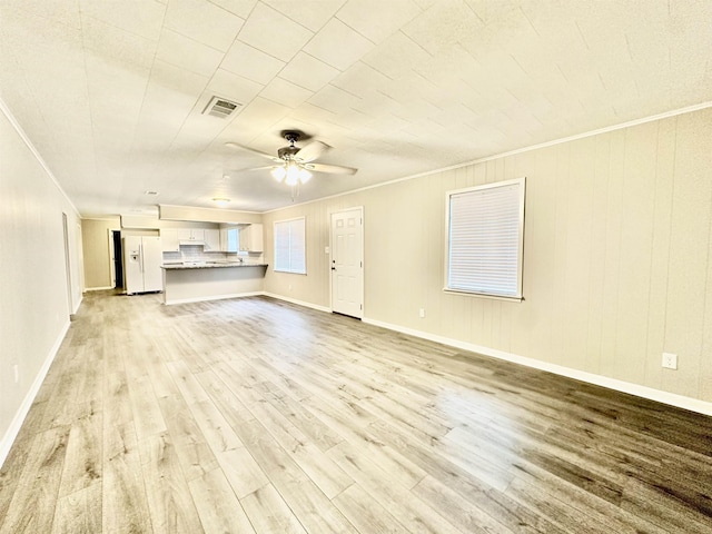 unfurnished living room featuring ceiling fan, light hardwood / wood-style floors, and crown molding