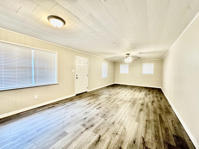 interior space featuring hardwood / wood-style floors, ceiling fan, and ornamental molding