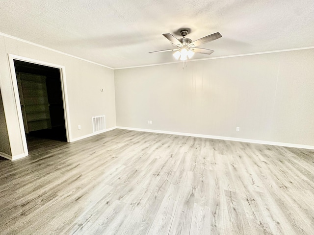 empty room with crown molding, ceiling fan, a textured ceiling, and light wood-type flooring