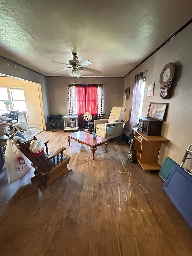 miscellaneous room featuring hardwood / wood-style flooring, ceiling fan, and a textured ceiling