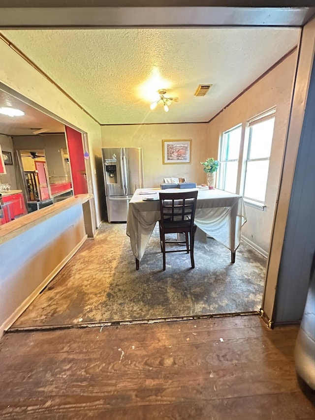 dining area featuring a textured ceiling and hardwood / wood-style flooring