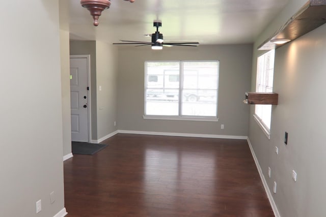 interior space featuring ceiling fan, wood finished floors, and baseboards