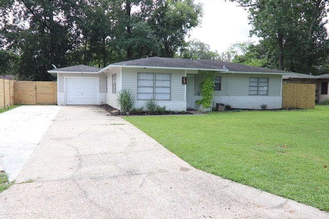 single story home featuring brick siding, an attached garage, fence, driveway, and a front lawn