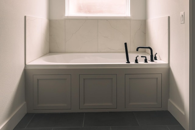 bathroom with a bathing tub and tile patterned floors