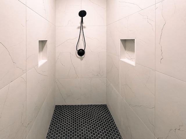 bathroom with tiled shower