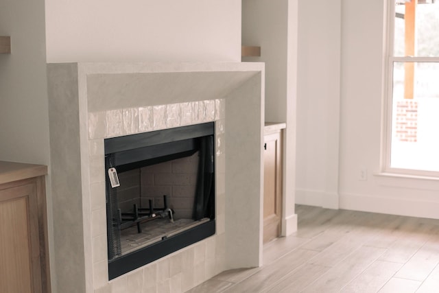 interior details with a fireplace and wood-type flooring