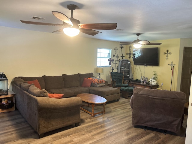 living room featuring hardwood / wood-style floors and ceiling fan