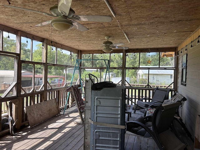 sunroom / solarium featuring ceiling fan and wood ceiling